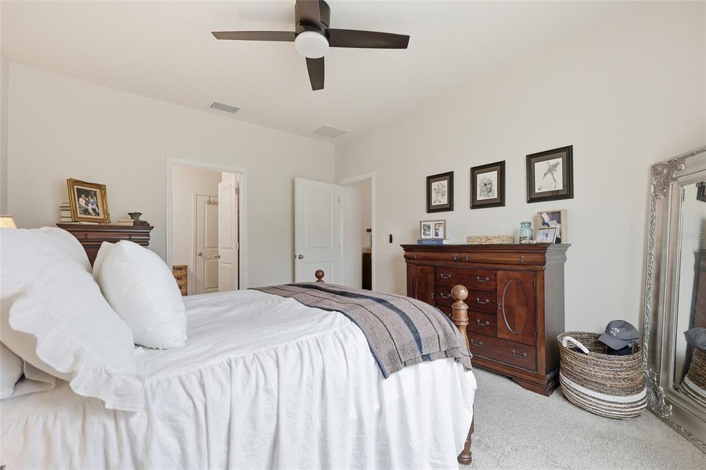 8261 Southwest 60th Avenue Gainesville, FL 32608 - Photo 21 of 34 a bedroom with a bed and ceiling fan