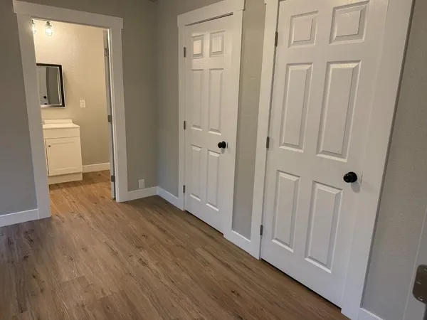 a view of a hallway with wooden floor