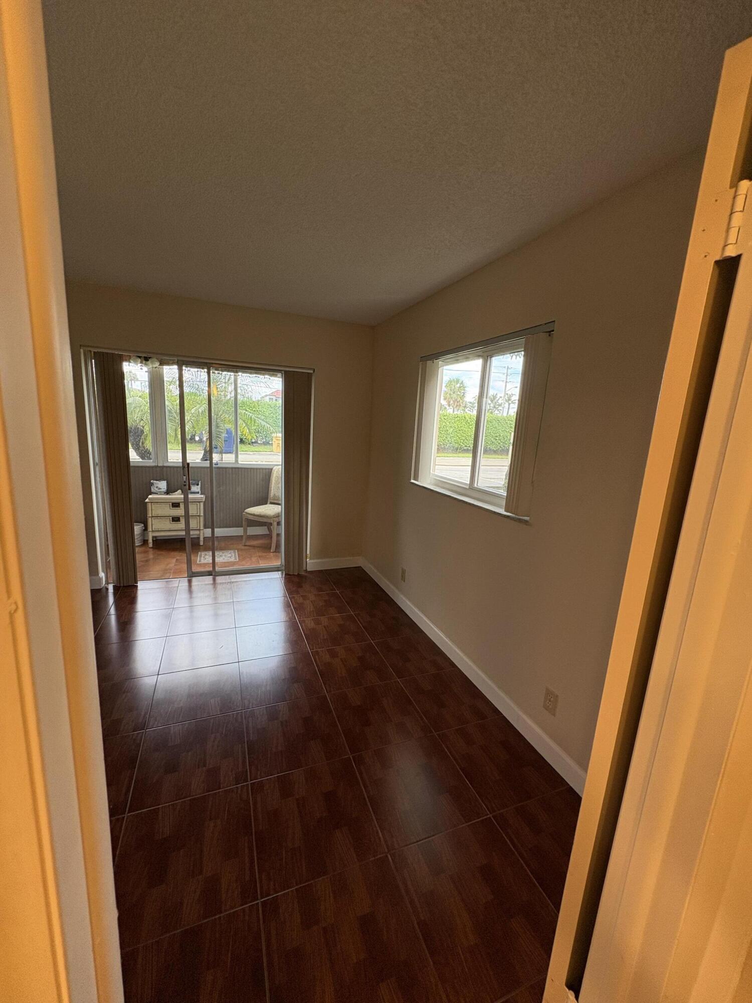 23 Flanders A Delray Beach, FL 33484 - Photo 14 of 21 an empty room with wooden floor and furniture