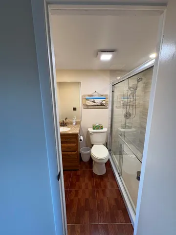 a bathroom with a toilet and a shower