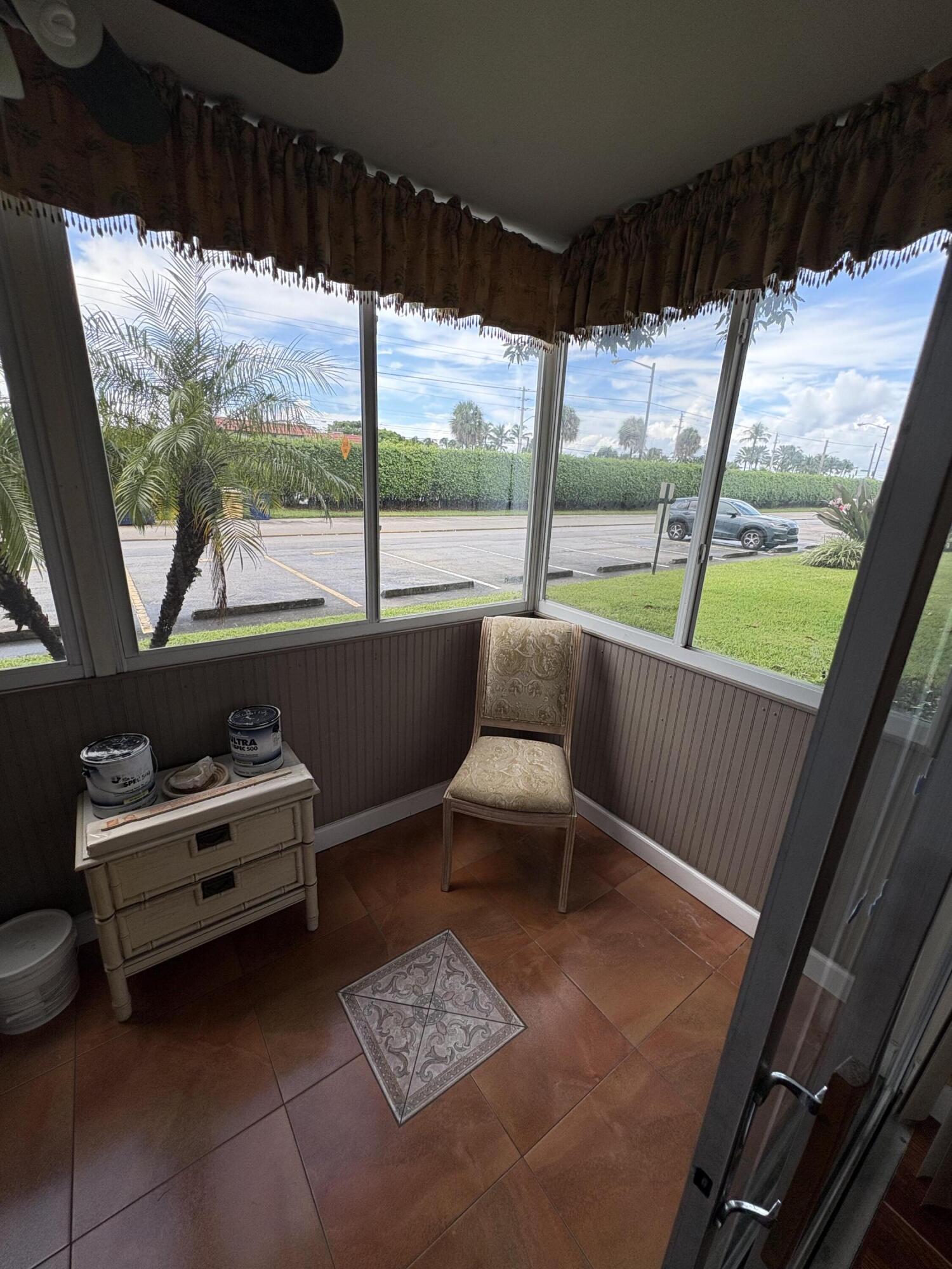 23 Flanders A Delray Beach, FL 33484 - Photo 19 of 21 a room with furniture and a large window