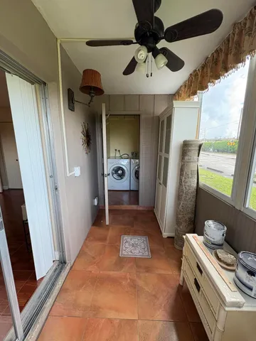 a room with stainless steel appliances a rug and a chandelier