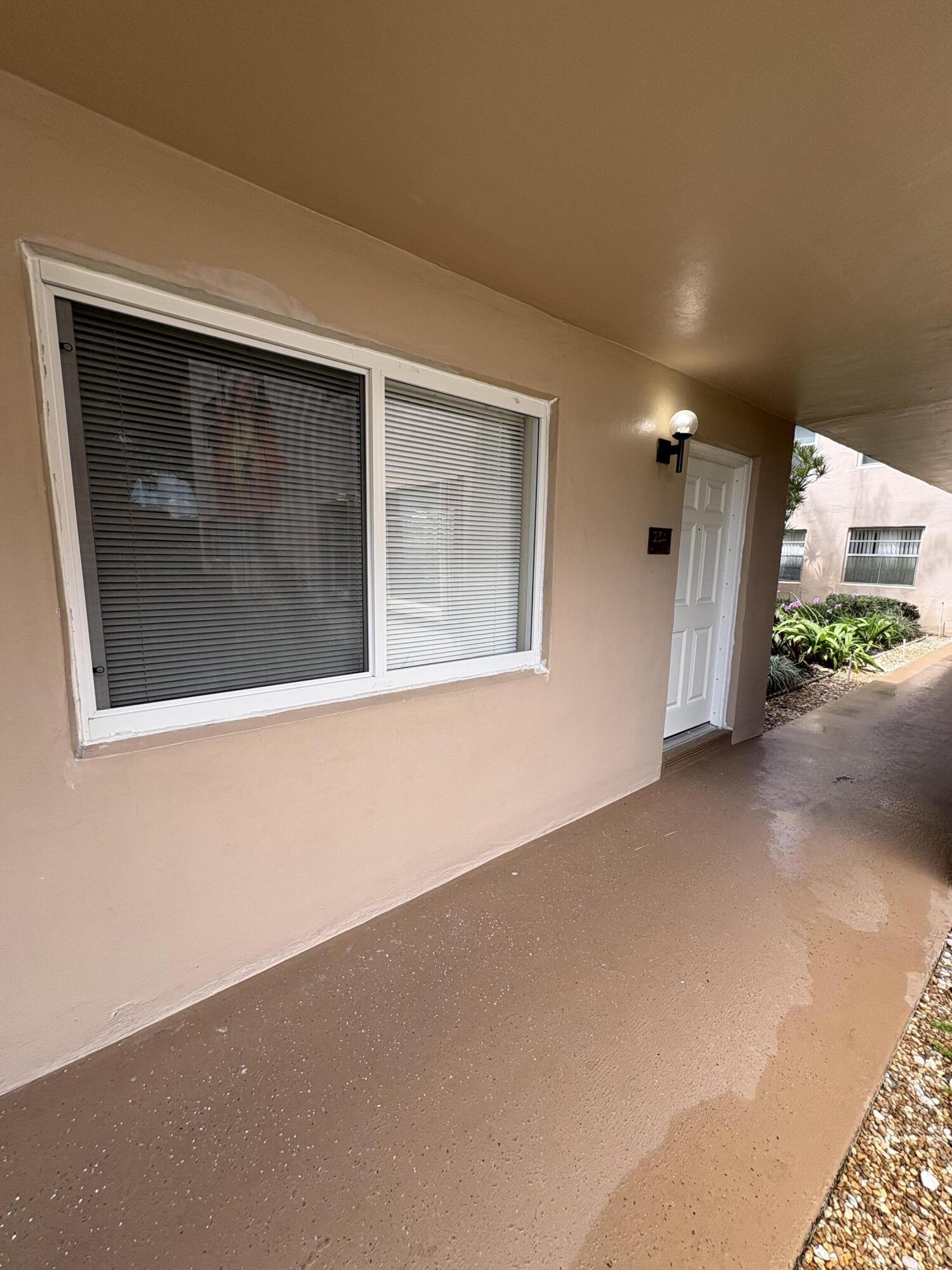 23 Flanders A Delray Beach, FL 33484 - Photo 2 of 21 a view of a house with a garage