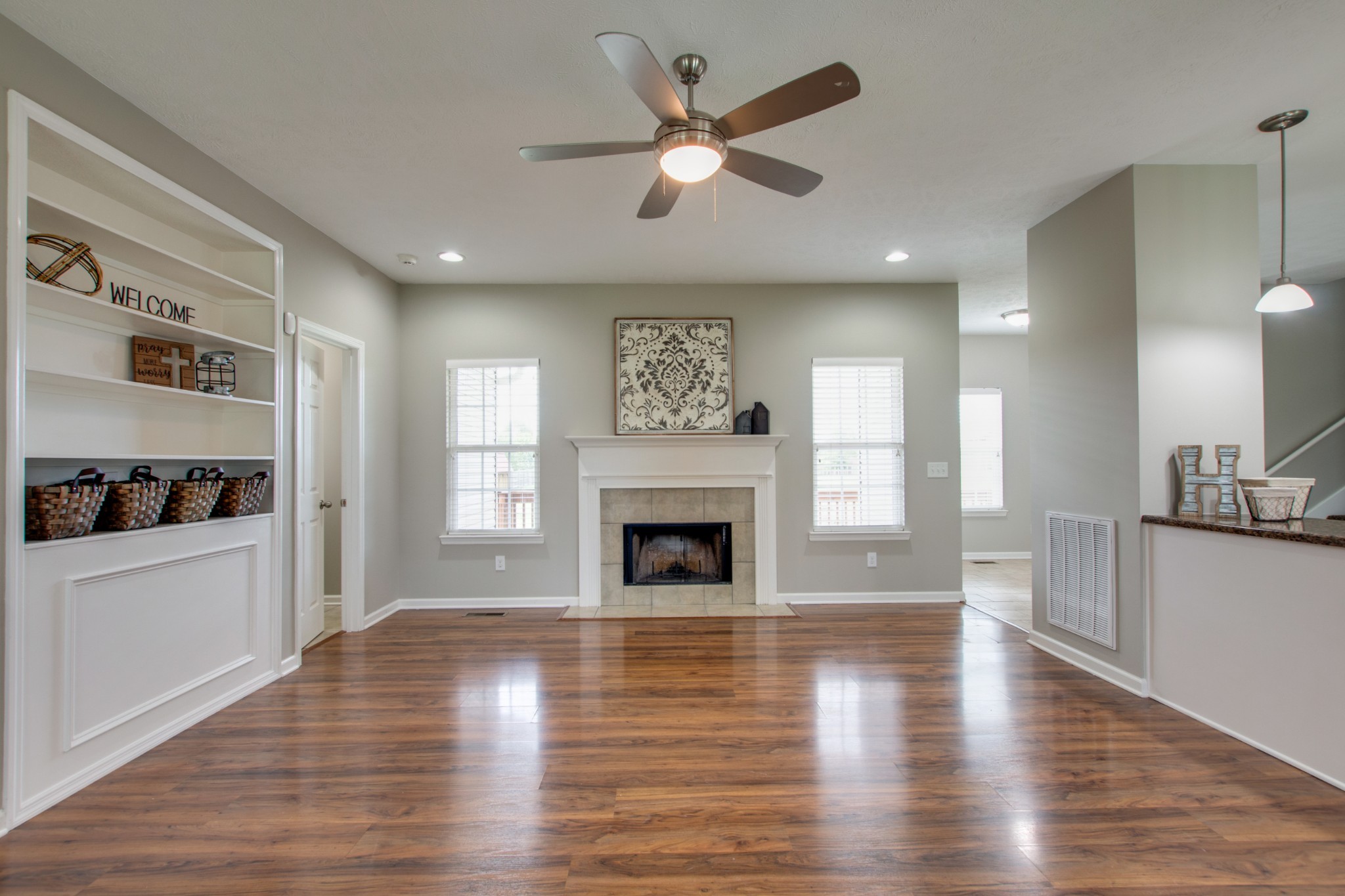 141 Philadelphia Road Lebanon, TN 37087 - Photo 4 of 31 a view of a livingroom with a fireplace a ceiling fan and windows