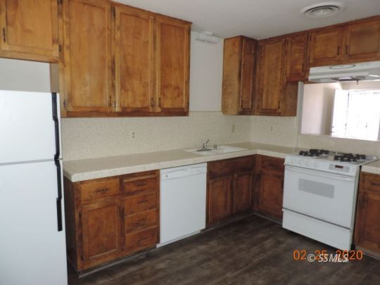 509 Commercial Avenue Ridgecrest, CA 93555 - Photo 4 of 8 a kitchen with a sink cabinets and a window