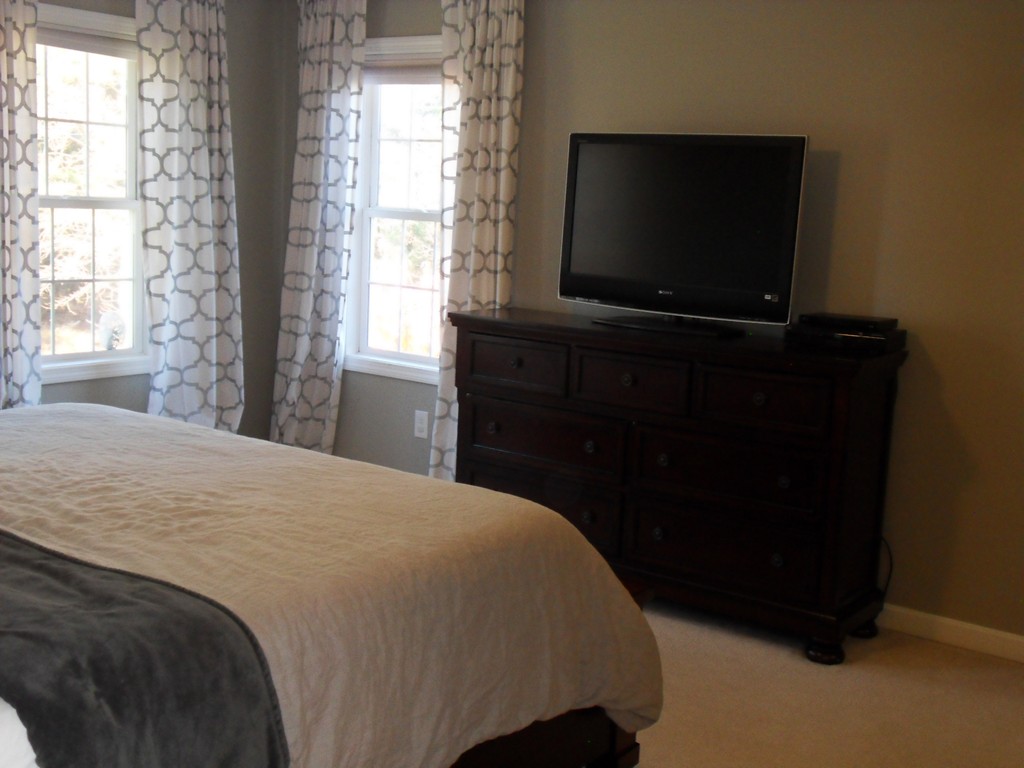99 Freeman Road Charlton, MA 01507 - Photo 18 of 29 a bedroom with a bed and a flat tv screen on dresser