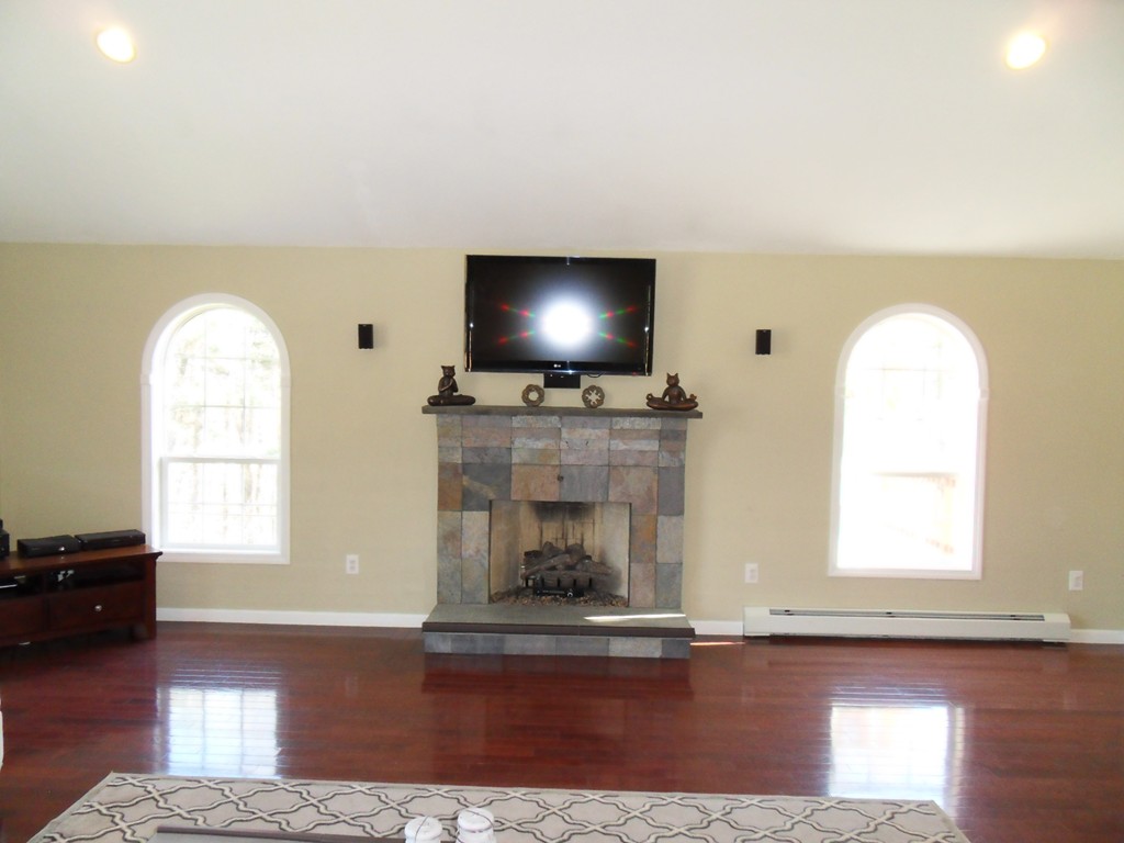 99 Freeman Road Charlton, MA 01507 - Photo 6 of 29 an empty room with fireplace and windows