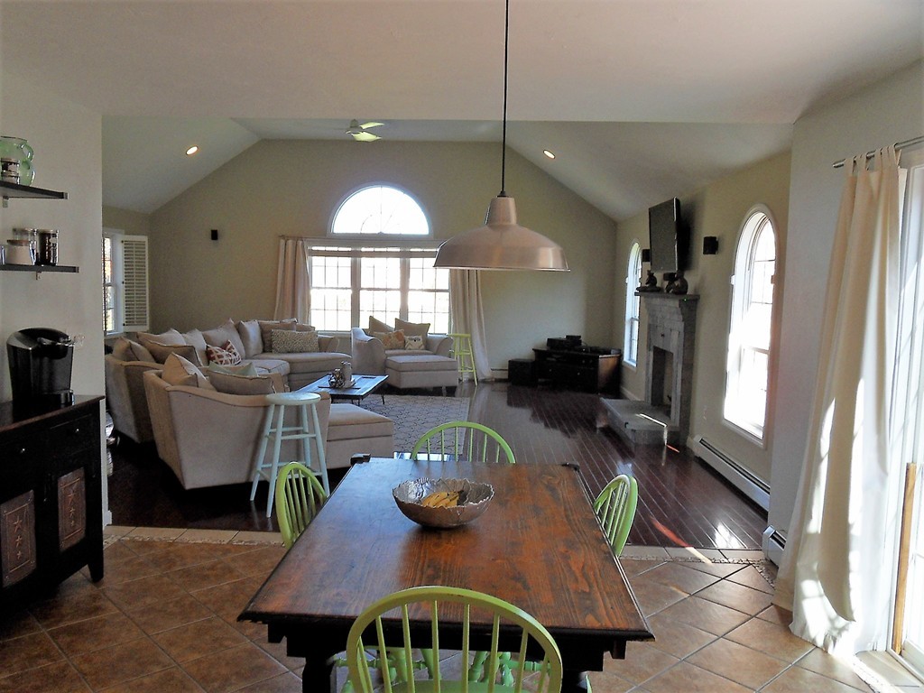 99 Freeman Road Charlton, MA 01507 - Photo 7 of 29 a dining room with furniture a large window and a chandelier
