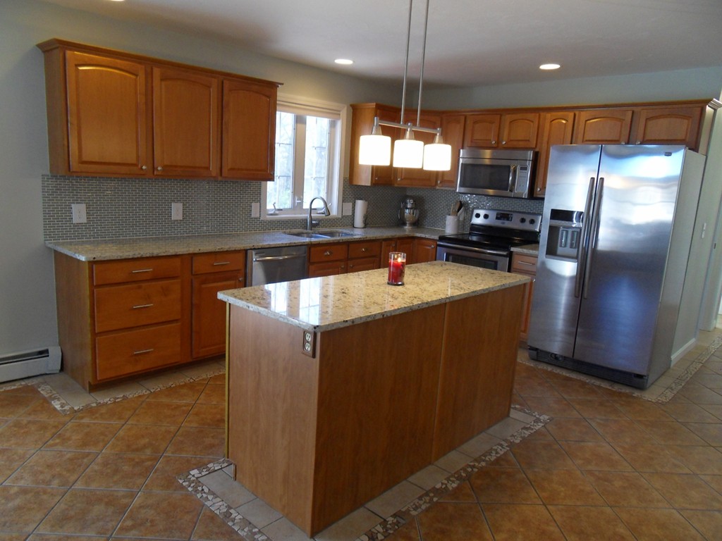 99 Freeman Road Charlton, MA 01507 - Photo 9 of 29 a kitchen with stainless steel appliances granite countertop a refrigerator a sink a stove a counter space and cabinets