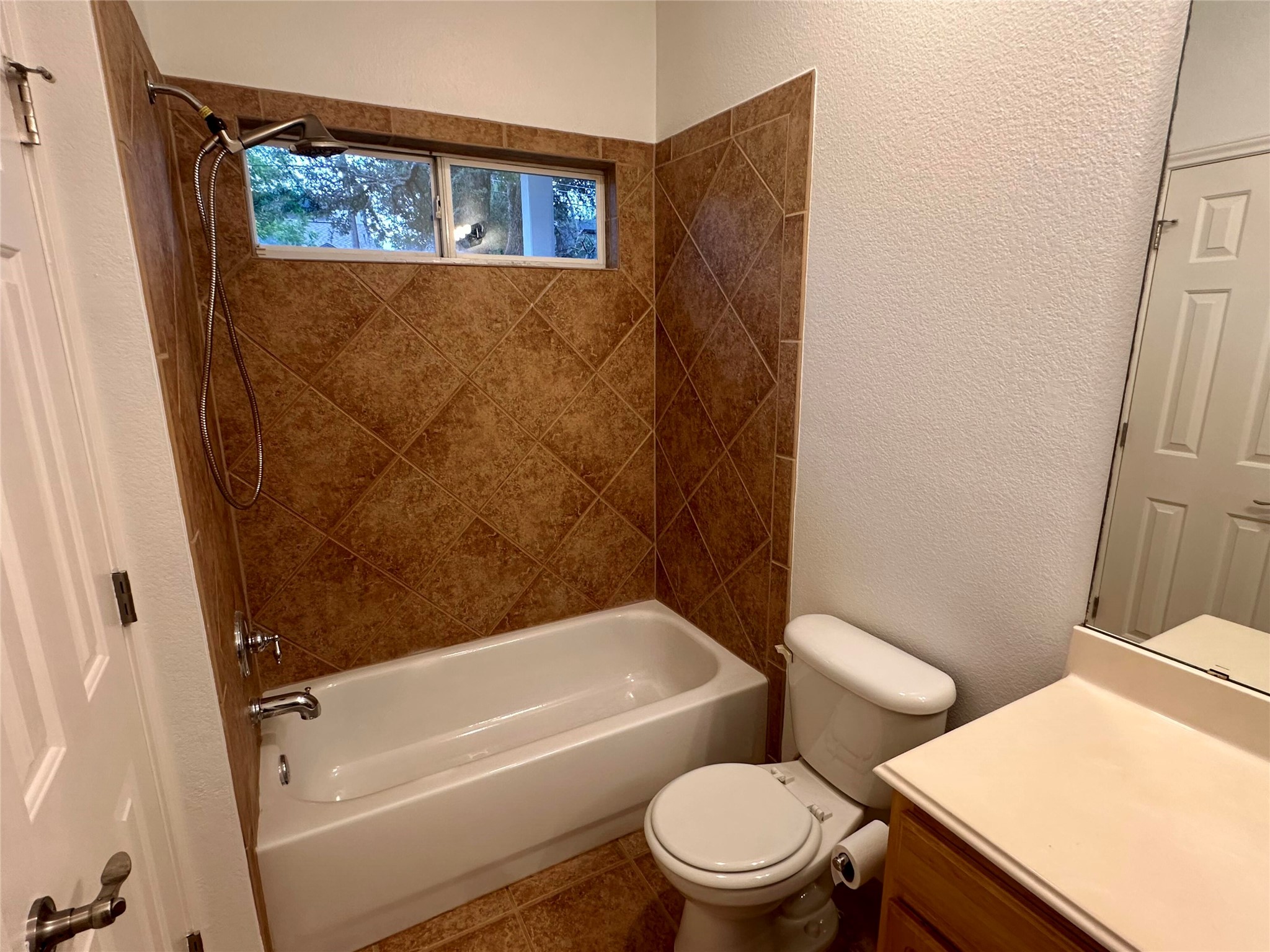 1122 Mansell Avenue Austin, TX 78721 - Photo 22 of 29 a white toilet sitting next to a bath tub