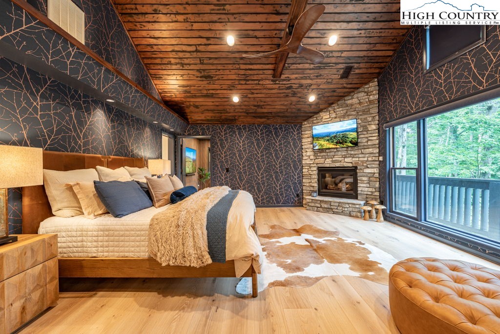 102 Ridge Drive Linville, NC 28646 - Photo 19 of 48 a bedroom with bed and a fireplace