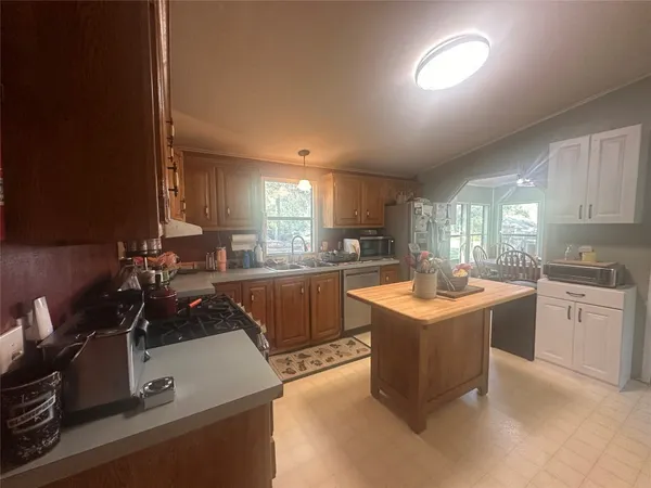a kitchen with a sink stove and cabinets