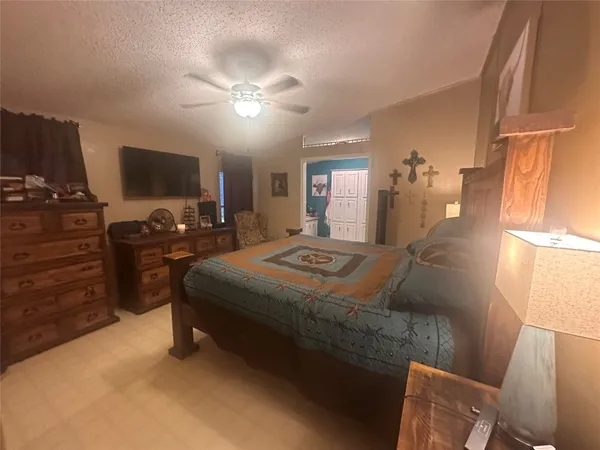 a bedroom with a bed and flat screen tv