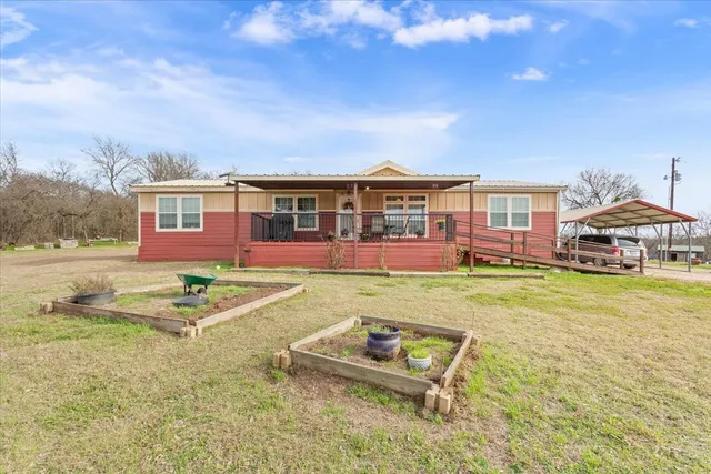 a view of a house with a backyard porch and sitting area