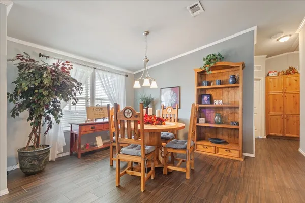 a view of a dining room with furniture kitchen and wooden floor