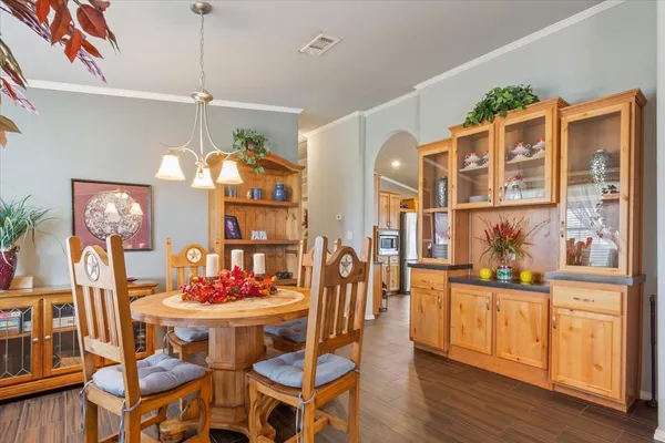 a kitchen that has a lot of cabinets and wooden floor