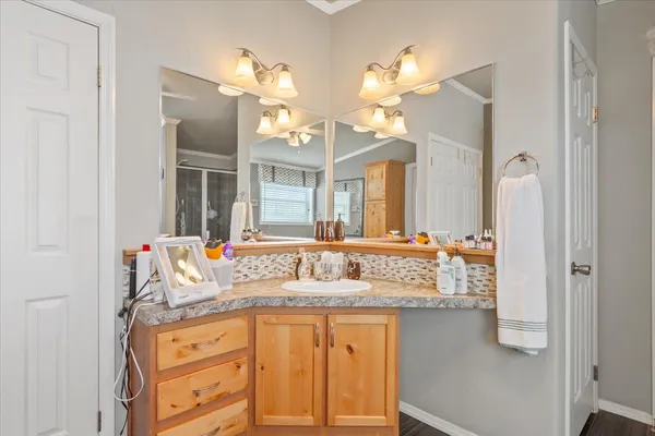 a bathroom with a granite countertop sink toilet and shower