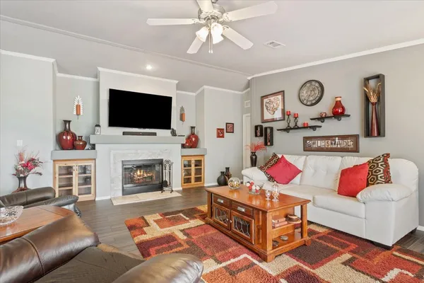 a living room with furniture a flat screen tv and a fireplace