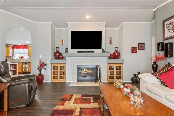 a living room with furniture a flat screen tv and a fireplace