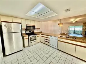 a kitchen with granite countertop cabinets stainless steel appliances and a counter space