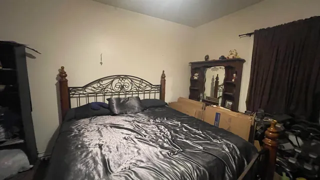 a bedroom with a bed and a mirror