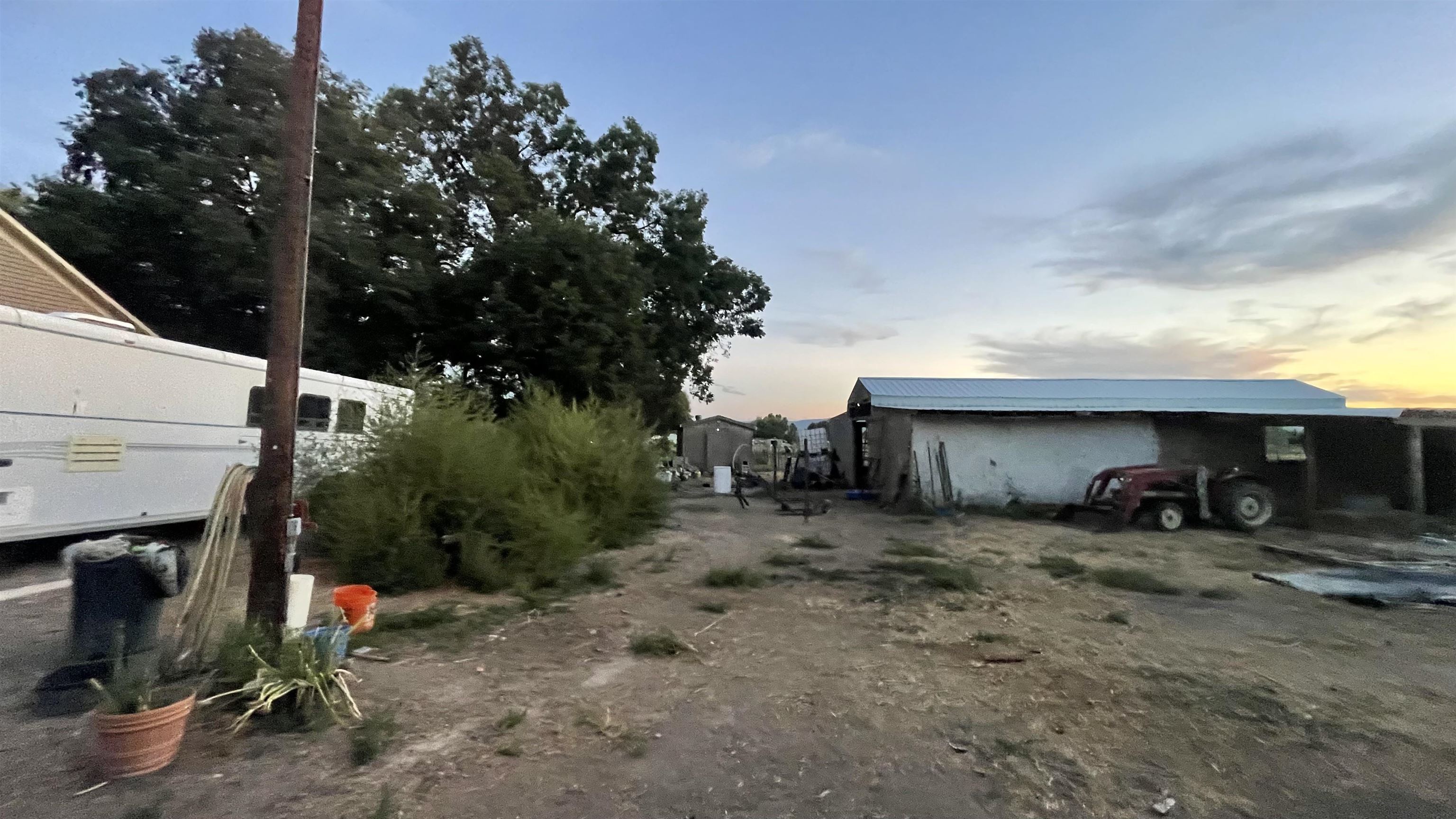 3049 F F 3/4 Road Grand Junction, CO 81504 - Photo 14 of 19 a view of a fire pit with some trees in the background