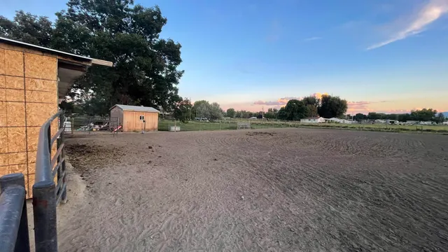 a living room with furniture a flat screen tv and kitchen view