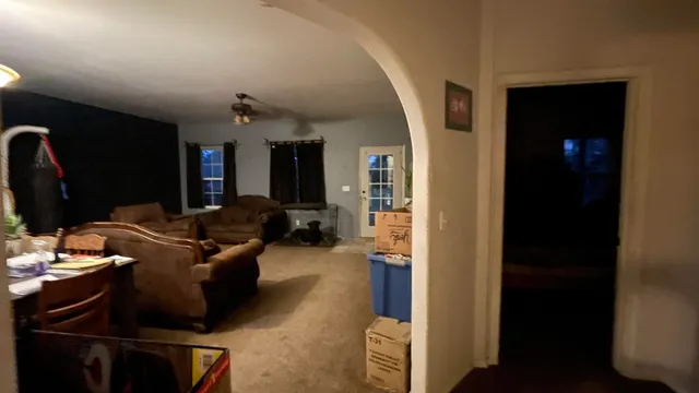 a utility room with dryer washer and a view of living room