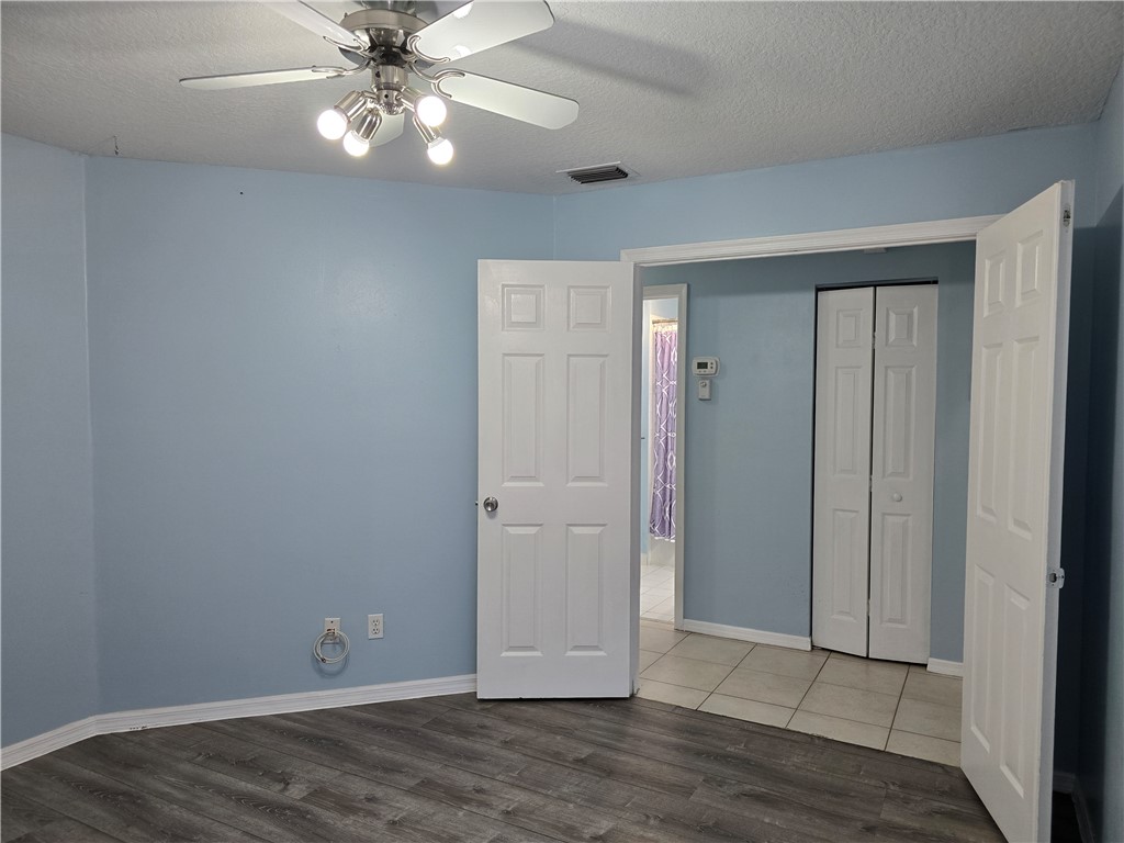 481 10th Place Vero Beach, FL 32960 - Photo 16 of 20 an empty room with wooden floor closet fan and windows