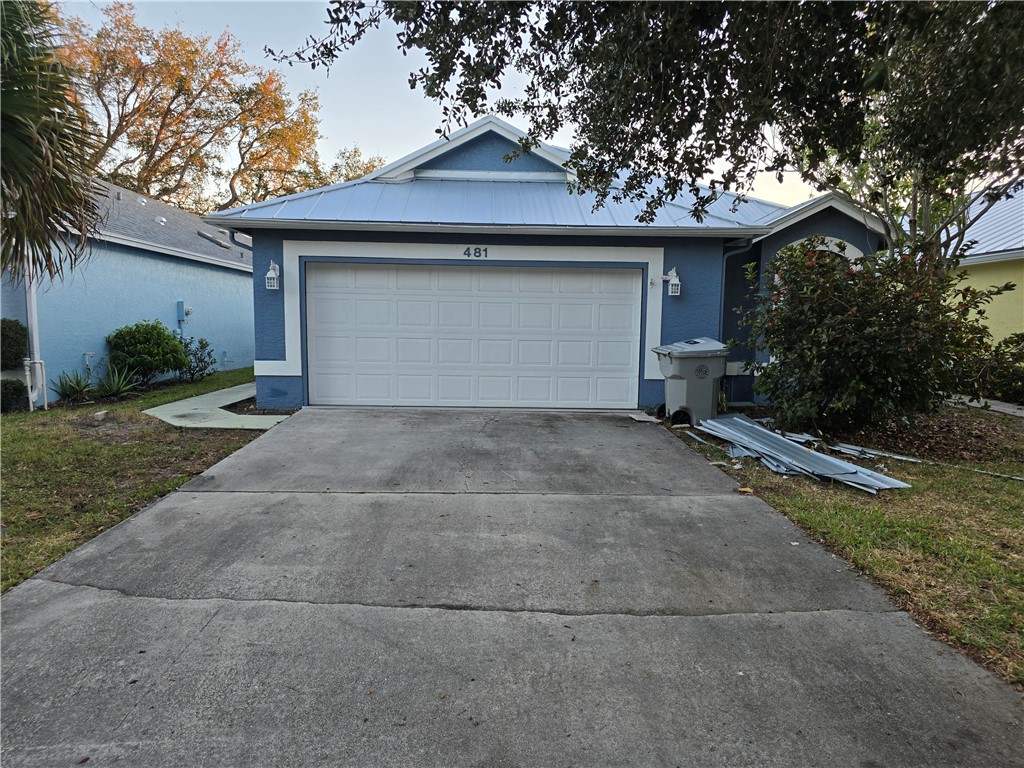 481 10th Place Vero Beach, FL 32960 - Photo 20 of 20 a front view of a house with a yard and garage