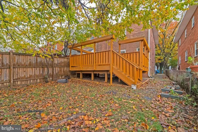 a view of a brick house with a large trees