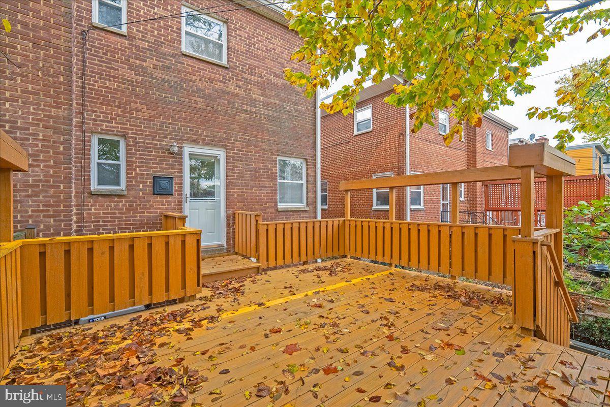 4411 Harrison Street Northwest Washington, DC 20015 - Photo 28 of 38 a view of a brick house with a large trees