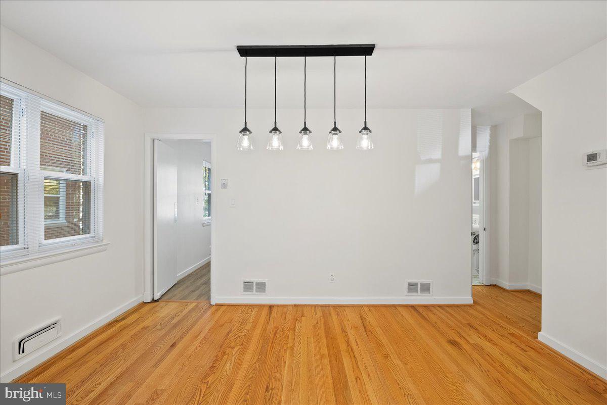 4411 Harrison Street Northwest Washington, DC 20015 - Photo 8 of 38 an empty room with wooden floor and windows