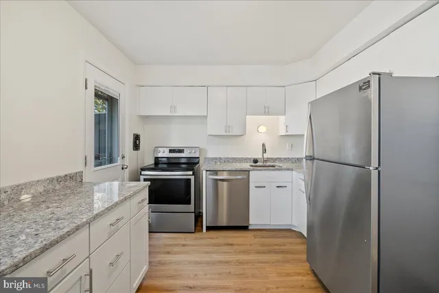 a kitchen with a refrigerator stove and sink