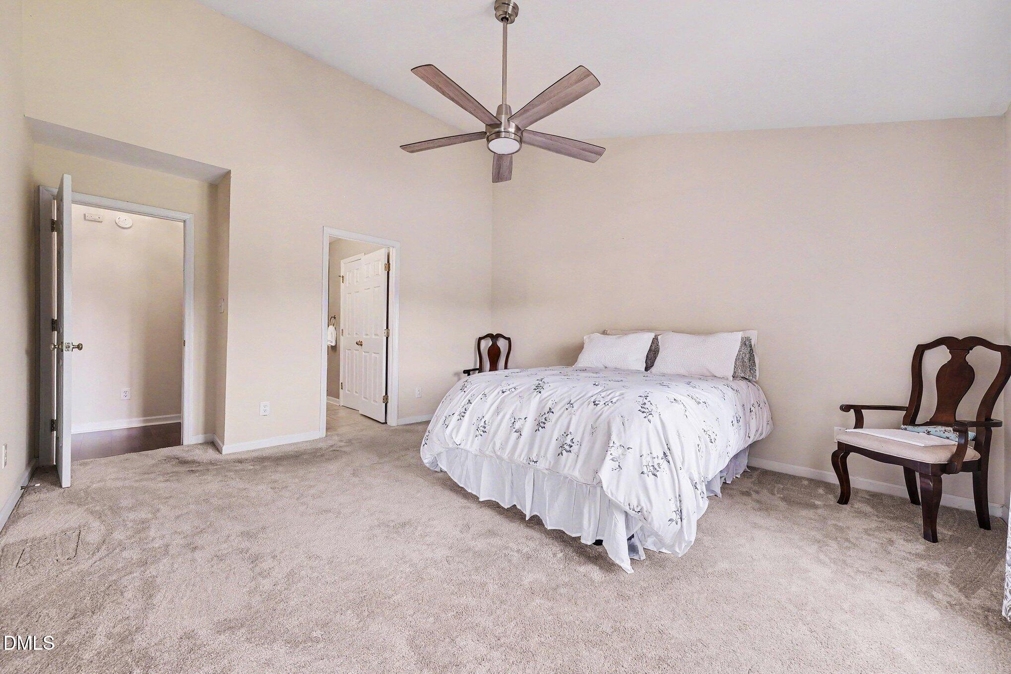 132 Springfork Drive Cary, NC 27513 - Photo 25 of 28 a spacious bedroom with a bed and ceiling fan