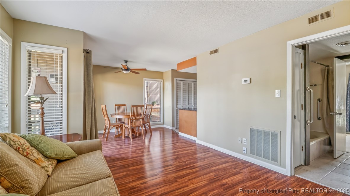 115 Beulah Hill Road South, Unit 111 Pinehurst, NC 28374 - Photo 11 of 32 a living room with furniture and a wooden floor