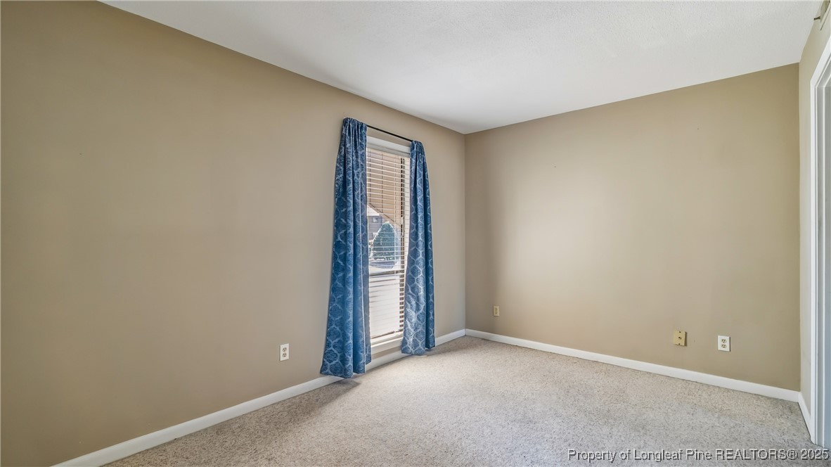 115 Beulah Hill Road South, Unit 111 Pinehurst, NC 28374 - Photo 14 of 32 an empty room with windows