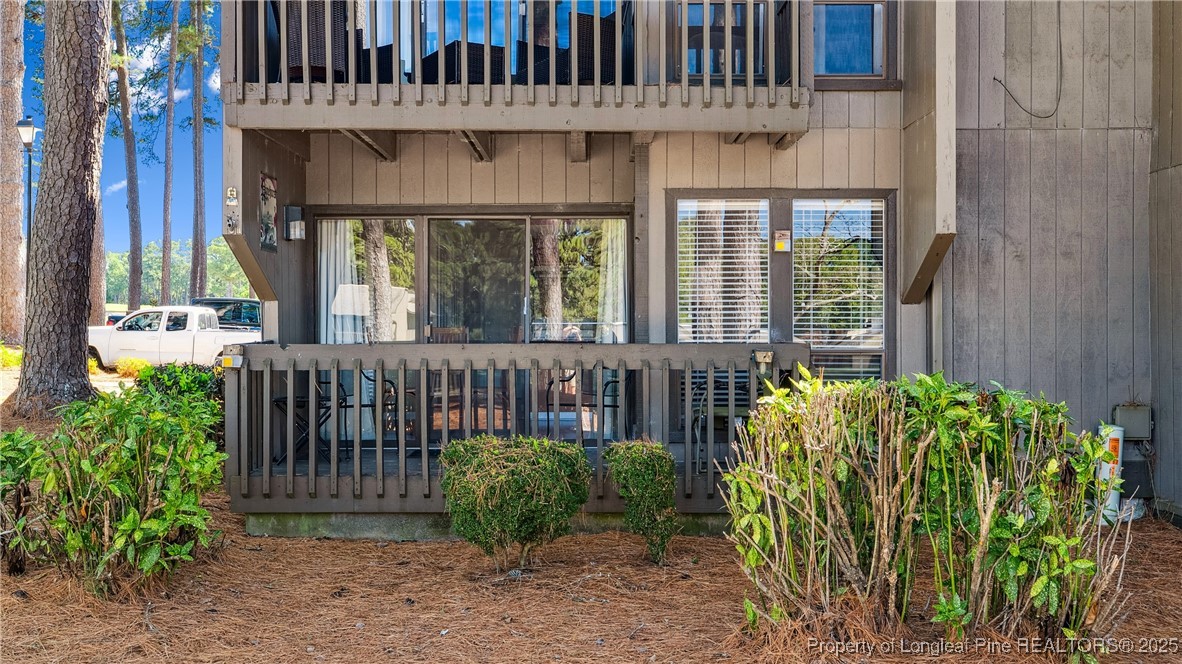115 Beulah Hill Road South, Unit 111 Pinehurst, NC 28374 - Photo 21 of 32 a view of a brick house with large windows and plants