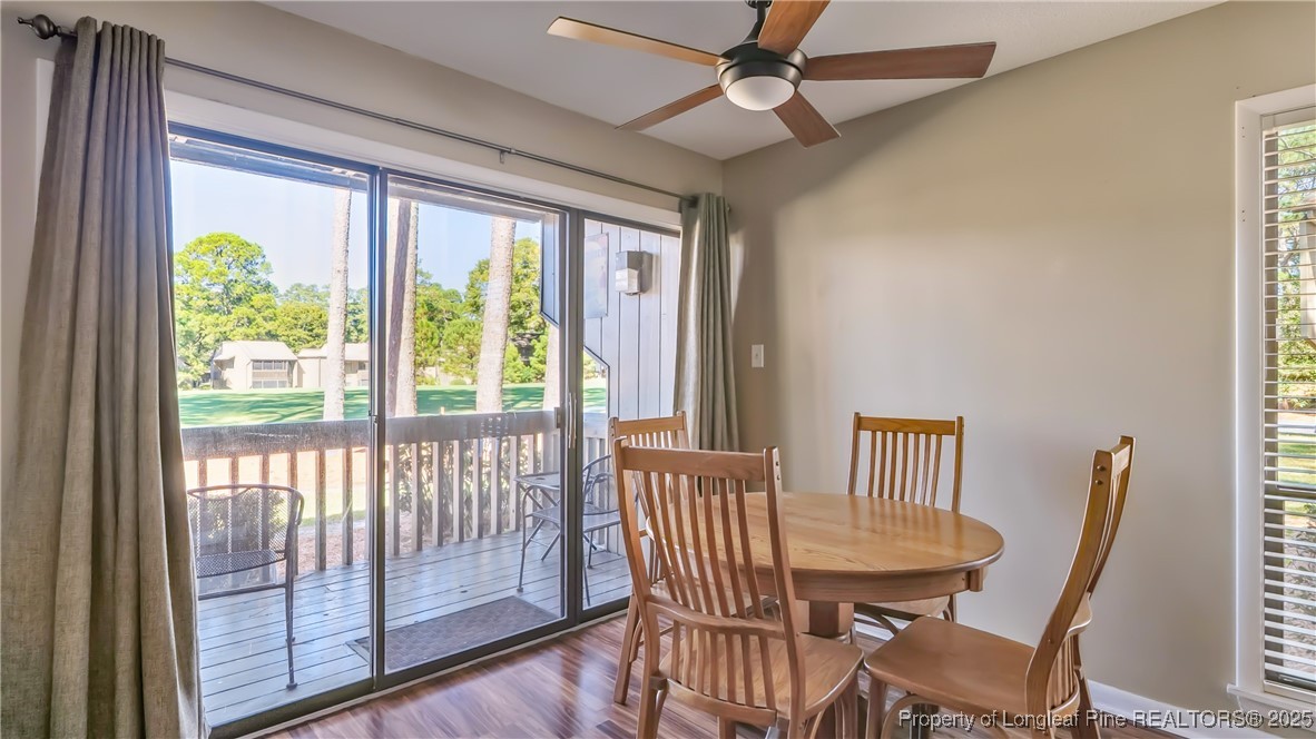 115 Beulah Hill Road South, Unit 111 Pinehurst, NC 28374 - Photo 7 of 32 a view of a dining room with furniture window and wooden floor