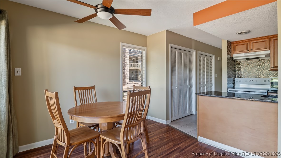 115 Beulah Hill Road South, Unit 111 Pinehurst, NC 28374 - Photo 8 of 32 a view of a dining room with furniture and window