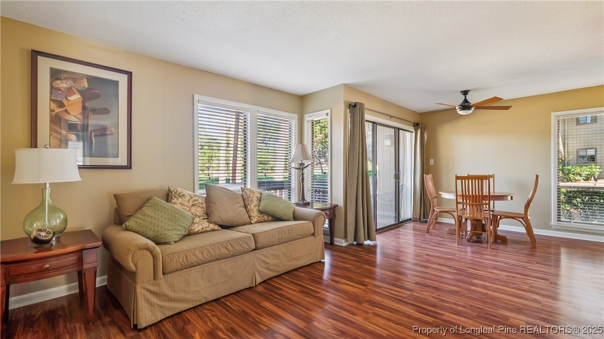 115 Beulah Hill Road South, Unit 111 Pinehurst, NC 28374 - Photo 10 of 32 a living room with furniture and a wooden floor