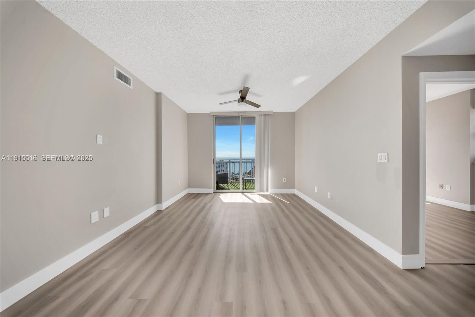 185 Southeast 14th Terrace, Unit 2008 Miami, FL 33131 - Photo 13 of 26 wooden floor in an empty room with a window