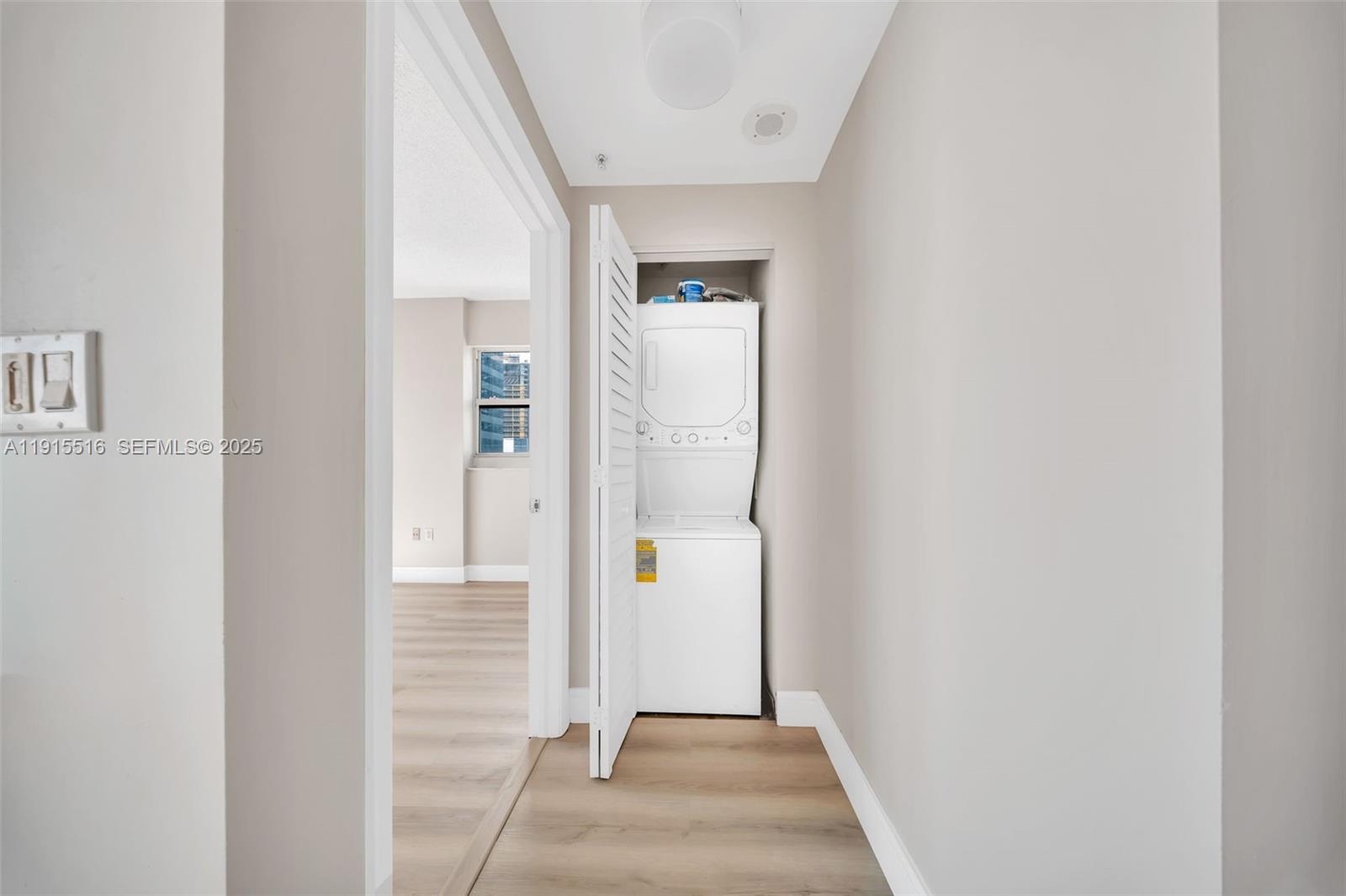 185 Southeast 14th Terrace, Unit 2008 Miami, FL 33131 - Photo 16 of 26 a view of a hallway with wooden floor and staircase