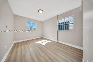 185 Southeast 14th Terrace, Unit 2008 Miami, FL 33131 - Photo 17 of 26 a view of empty room with wooden floor and fan
