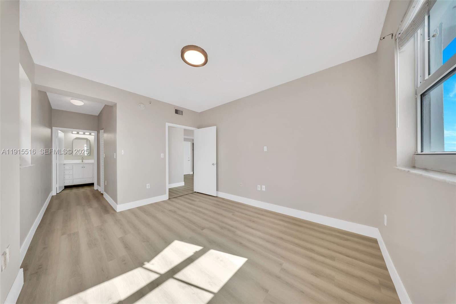185 Southeast 14th Terrace, Unit 2008 Miami, FL 33131 - Photo 18 of 26 a view of an empty room and window