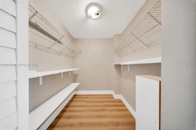 a bathroom with a granite countertop sink mirror vanity and toilet