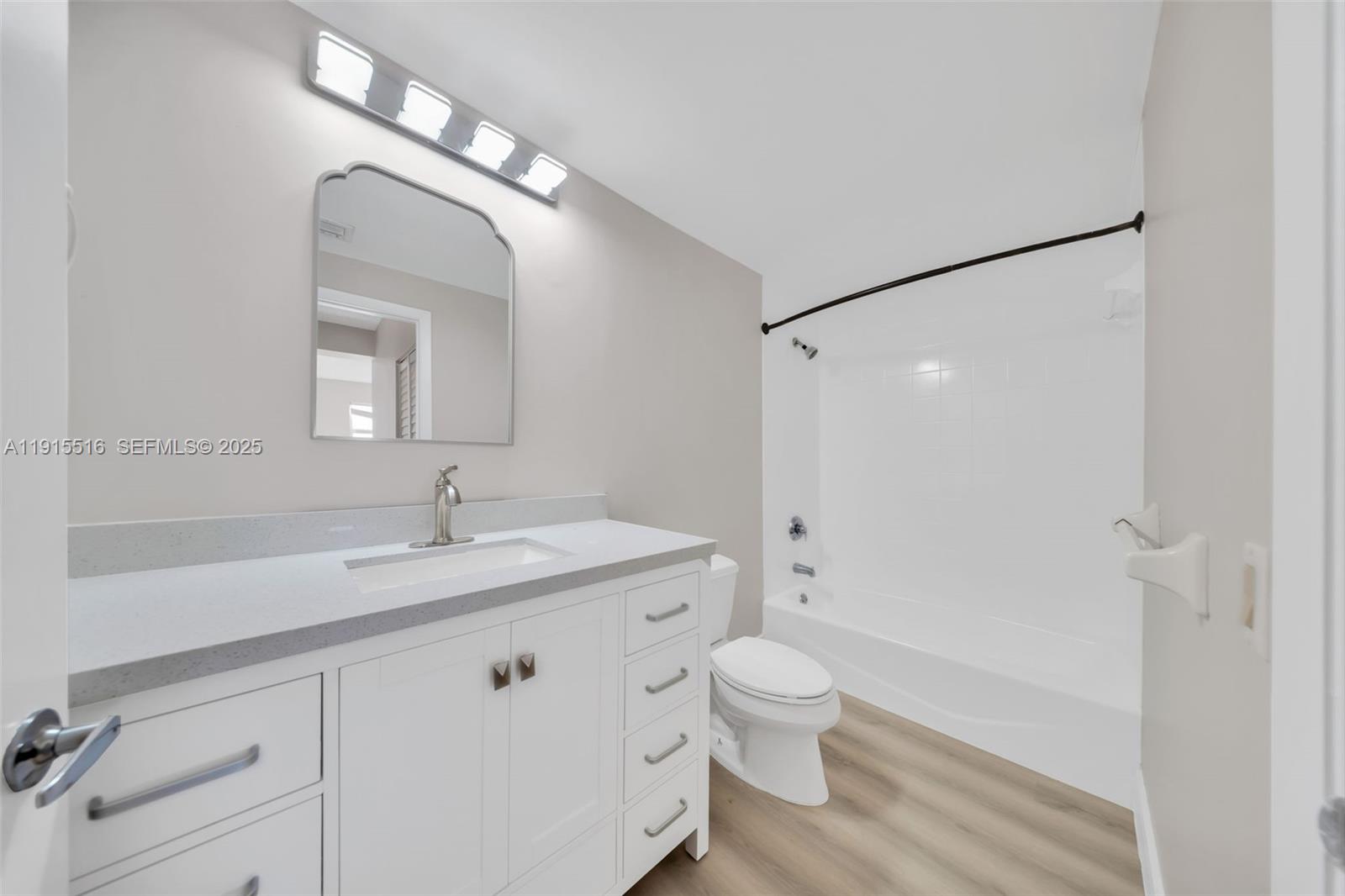 185 Southeast 14th Terrace, Unit 2008 Miami, FL 33131 - Photo 20 of 26 a bathroom with a granite countertop sink mirror vanity and toilet