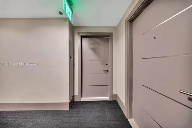 a view of a hallway and kitchen with furniture