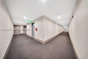 185 Southeast 14th Terrace, Unit 2008 Miami, FL 33131 - Photo 22 of 26 a view of a hallway and kitchen with furniture