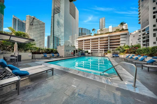 a swimming pool with outdoor seating and outdoor seating